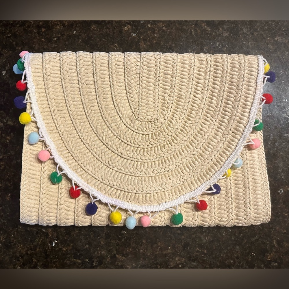 Oversized pompom clutch. New without tags. Never used. Non-smoking home.